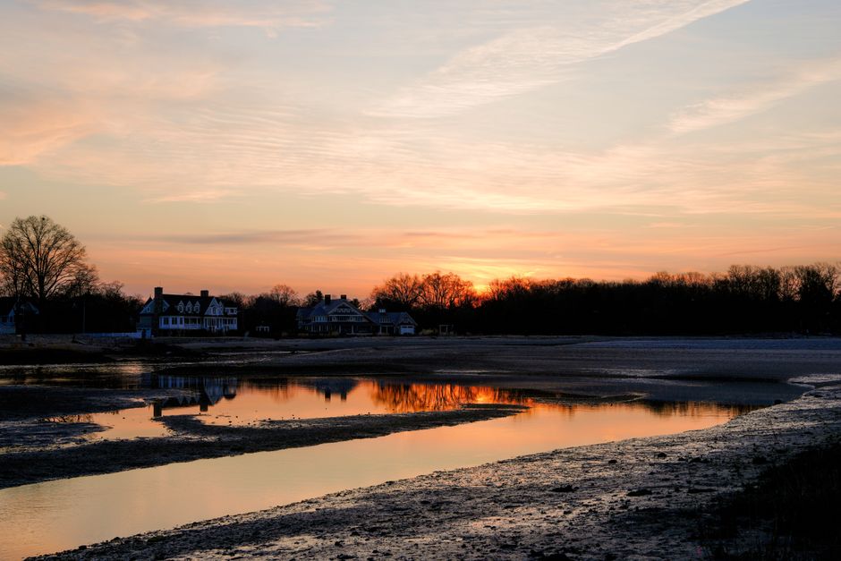 A tranquil sunrise over Cove Island Park in Stamford, Connecticut, reflecting on a calm in