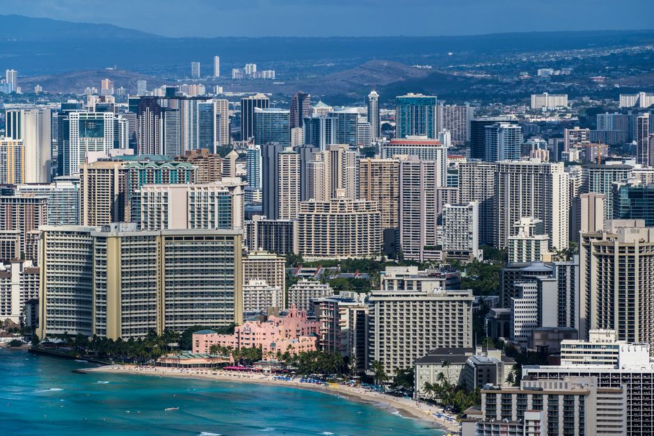 Explore the bustling skyline of Honolulu overlooking the famous Waikiki Beach.