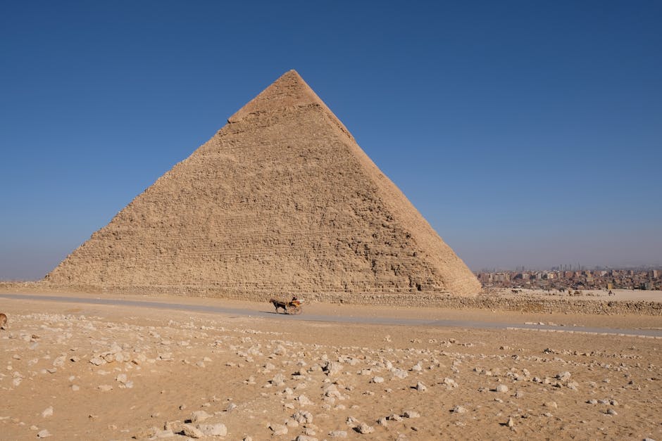 A majestic view of the Pyramid of Khafre in Giza, Egypt, under a bright blue sky.