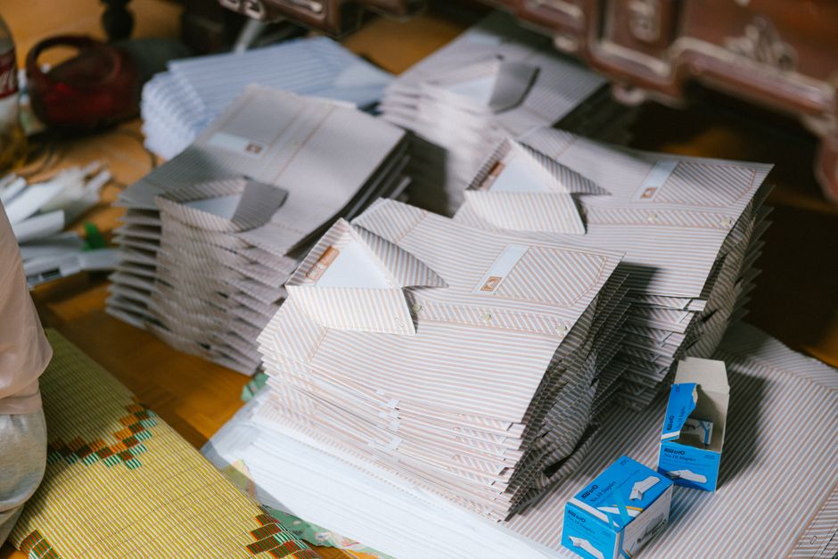 Stacks of folded striped paper with boxes indoors, showcasing organization and materials.
