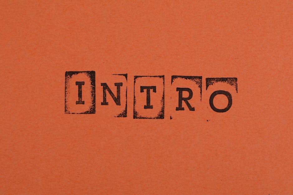 Close-up of the word INTRO stamped in black on an orange background, conveying a bold entrance.