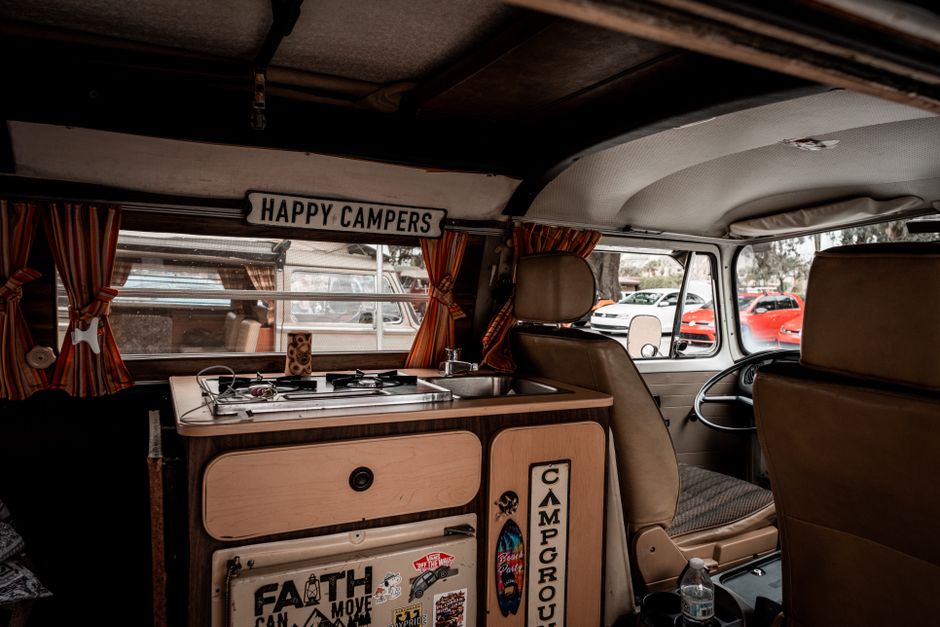 Explore the nostalgic interior of a vintage Volkswagen camper van equipped for adventure.