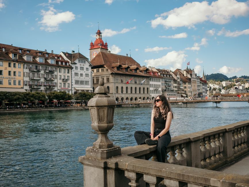 Relaxing by Luzern's waterfront with historic buildings and a picturesque river view.