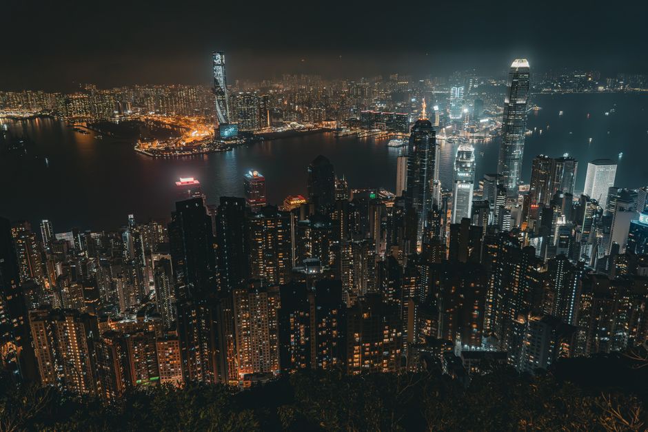 Breathtaking aerial view of Hong Kong skyline at night with Victoria Harbour lights.